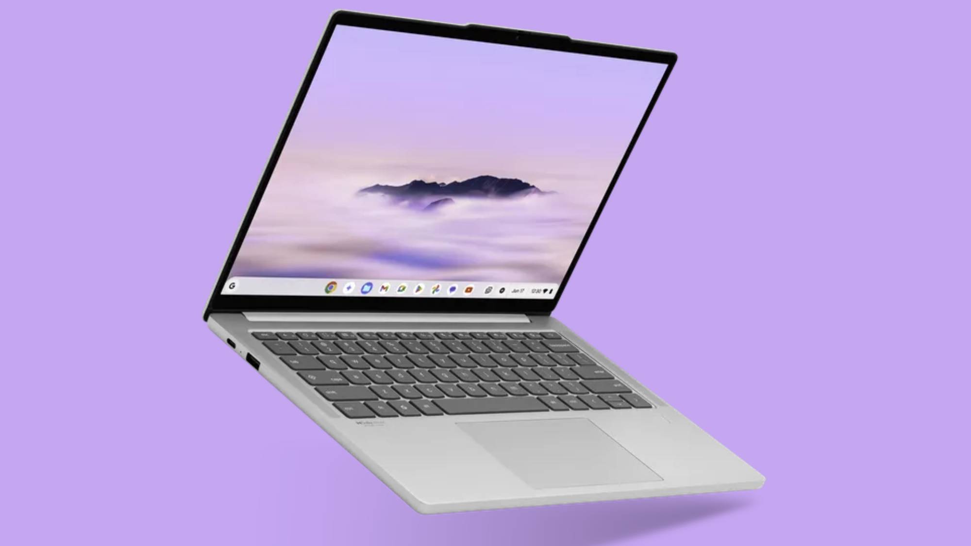 A silver Chromebook laptop is shown open against a purple background