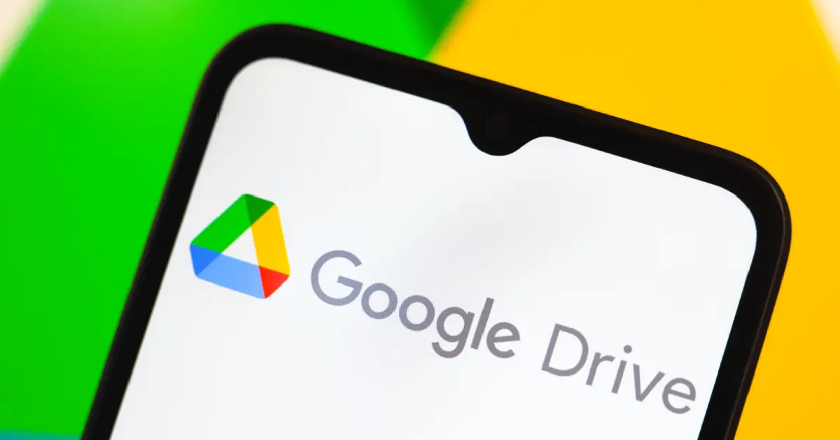 Google Drive logo on phone against a green and yellow background.
